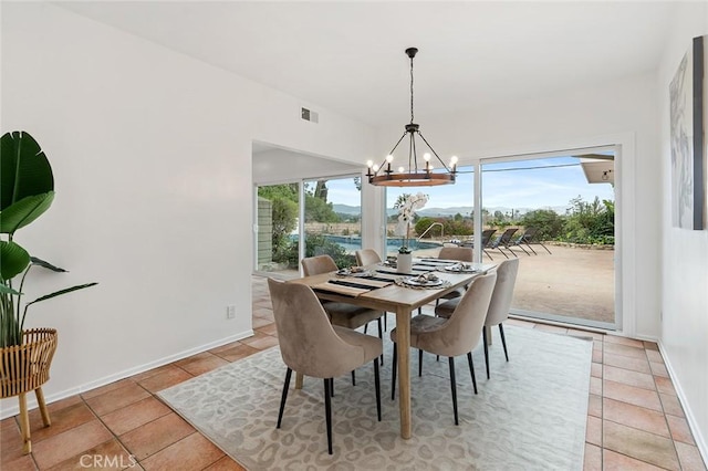 dining space with a notable chandelier, a wealth of natural light, and light tile patterned floors