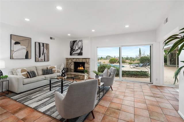 living room featuring a fireplace and light tile patterned floors