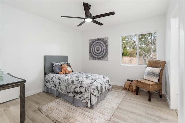 bedroom with ceiling fan and light wood-type flooring