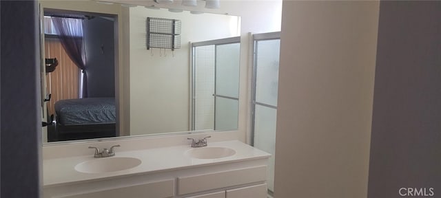 bathroom featuring vanity and a shower with shower door