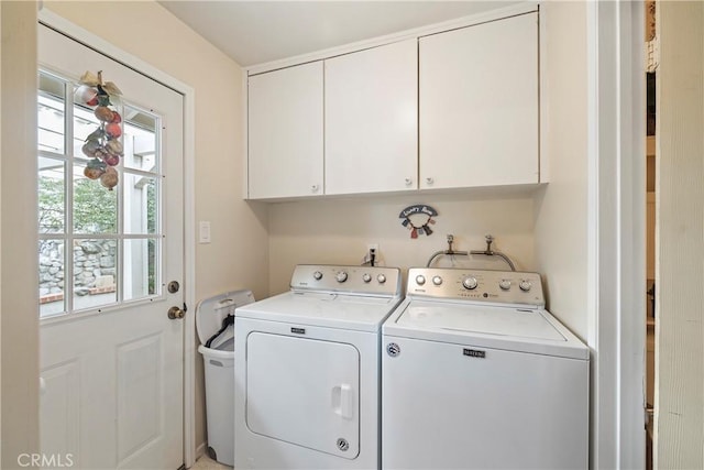 laundry area featuring cabinets and washer and clothes dryer