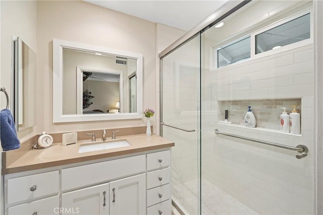 bathroom with vanity and a shower with shower door