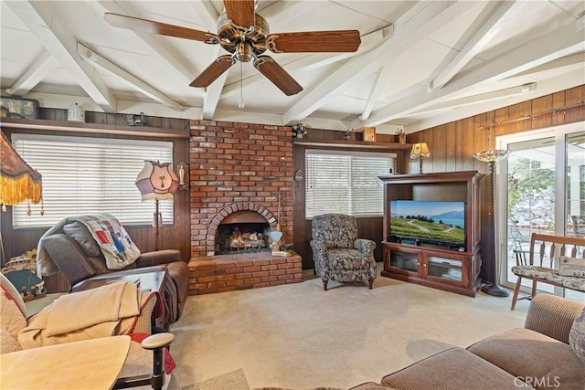 living room with ceiling fan, light colored carpet, wooden walls, and beamed ceiling