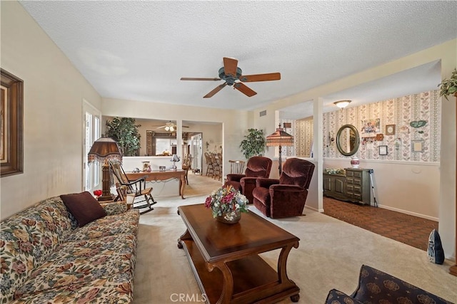 carpeted living room featuring a textured ceiling and ceiling fan