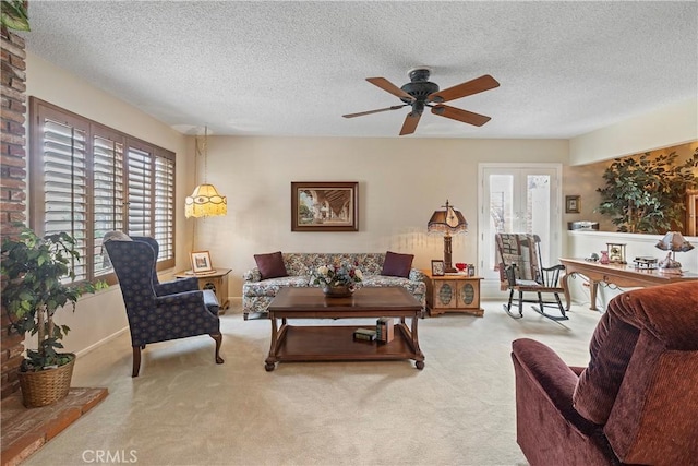 living room featuring a textured ceiling, light carpet, and plenty of natural light