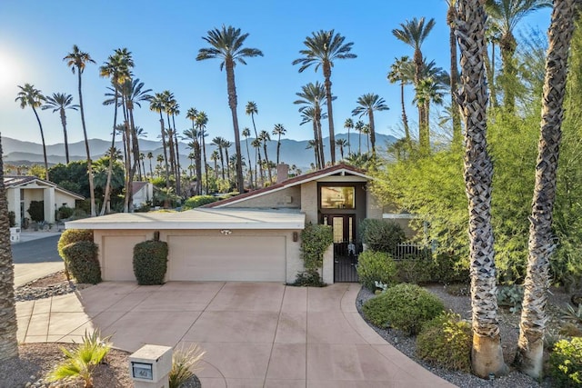 view of front of property featuring a mountain view and a garage