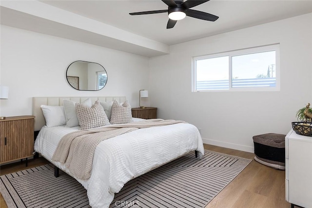 bedroom featuring ceiling fan, hardwood / wood-style floors, and radiator