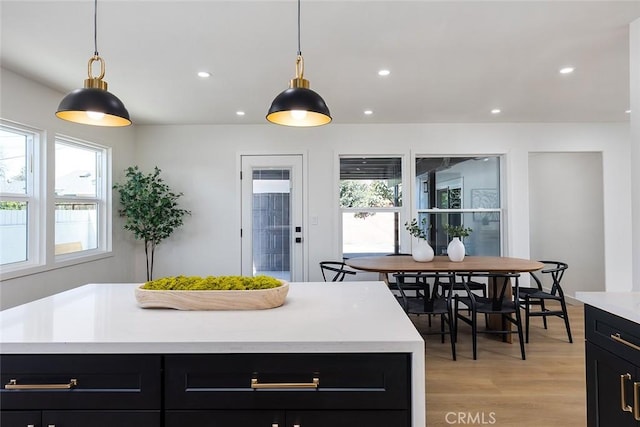 kitchen featuring a center island, light wood-type flooring, and pendant lighting