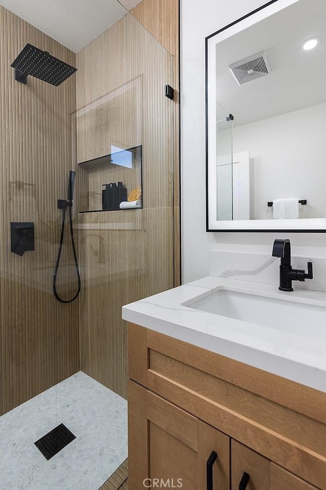 bathroom with walk in shower and vanity