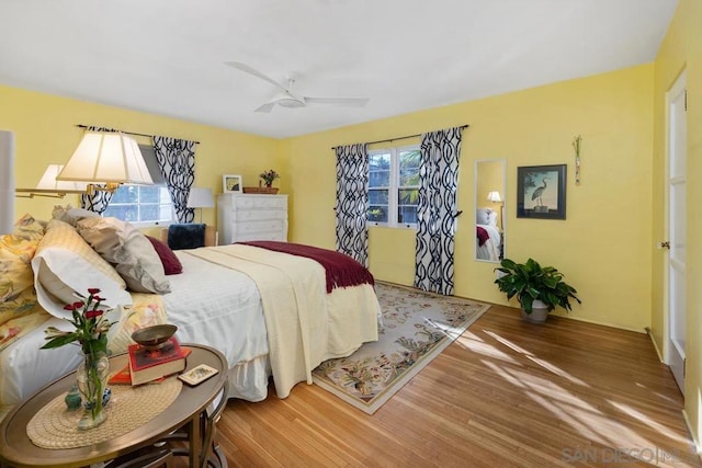 bedroom with ceiling fan and wood-type flooring