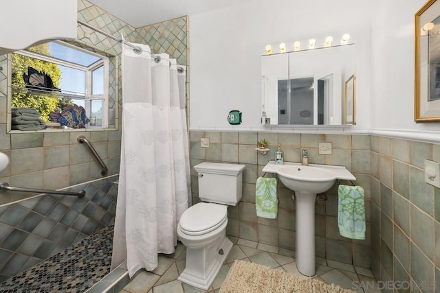 bathroom with toilet, tile patterned flooring, and walk in shower