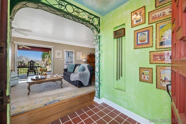 interior space featuring dark tile patterned flooring and ornamental molding