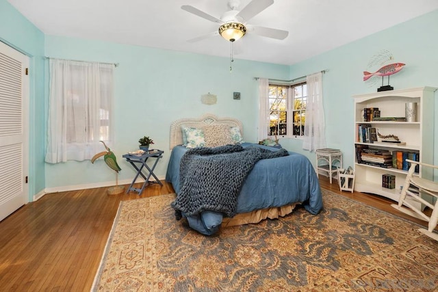 bedroom featuring ceiling fan and dark wood-type flooring