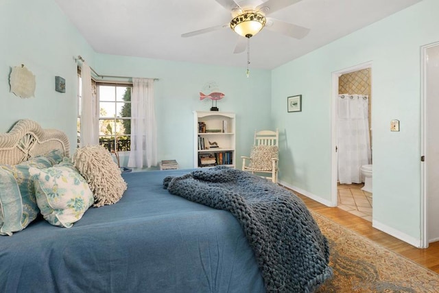 bedroom with ensuite bath, ceiling fan, and light hardwood / wood-style floors