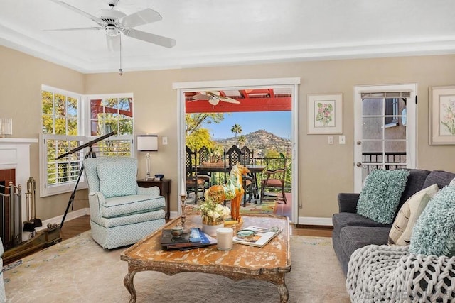 living room featuring wood-type flooring and ceiling fan