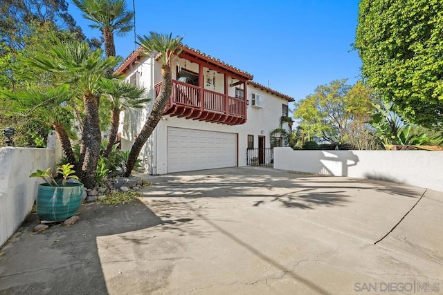 mediterranean / spanish-style home with a balcony and a garage