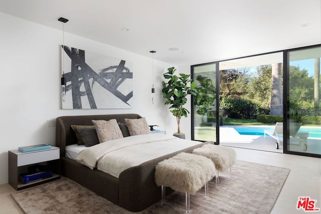 bedroom with floor to ceiling windows, multiple windows, and access to exterior