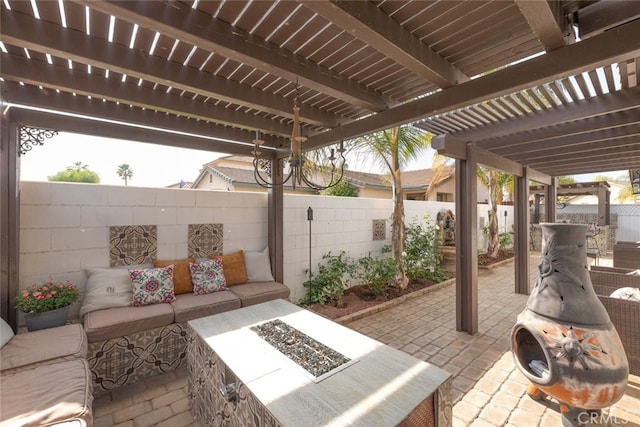 view of patio / terrace with a pergola and an outdoor living space with a fire pit