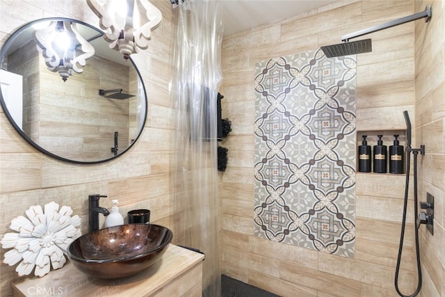 bathroom with sink and tiled shower