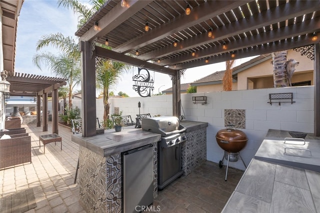 view of patio / terrace with an outdoor kitchen, grilling area, and a pergola