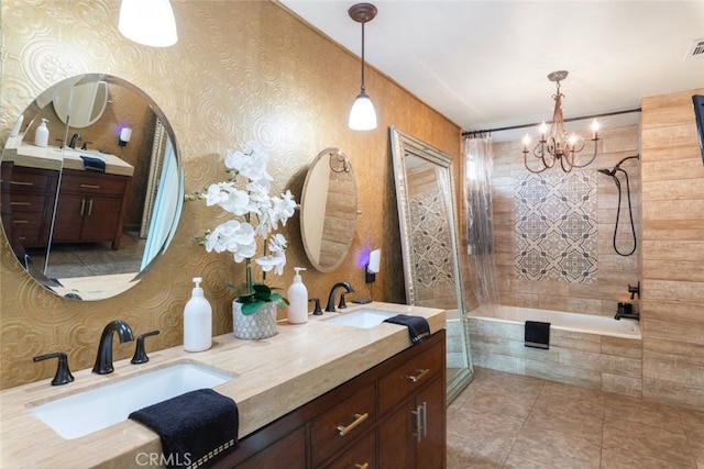 bathroom featuring tiled shower / bath, vanity, tile patterned floors, and a notable chandelier