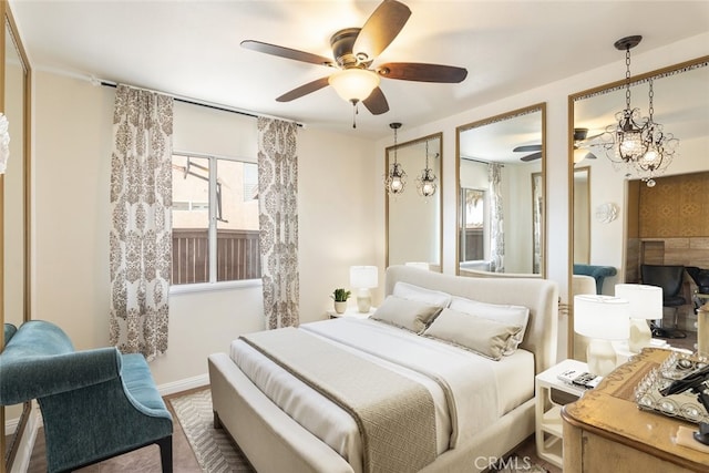 bedroom with ceiling fan with notable chandelier