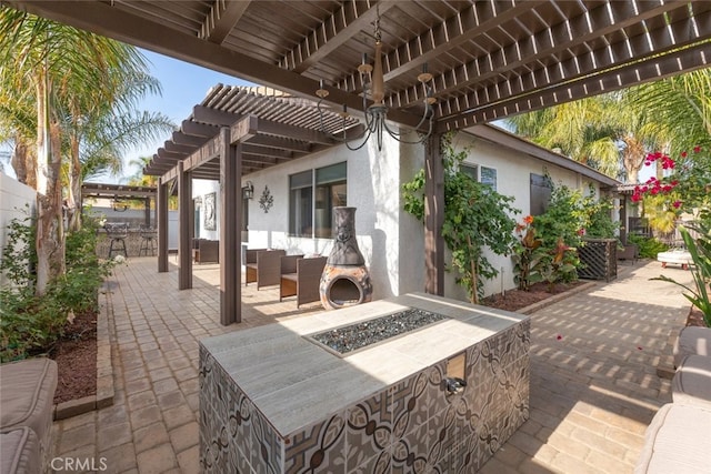 view of patio / terrace featuring a pergola and a fireplace