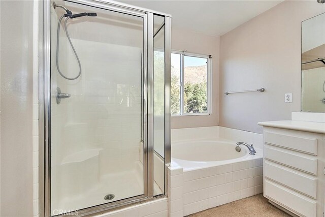 bathroom featuring plus walk in shower and vanity