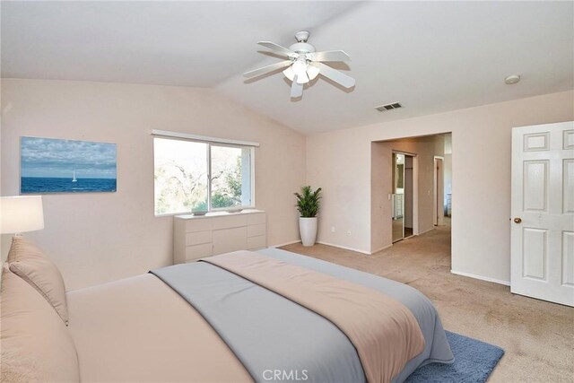 carpeted bedroom with ceiling fan and vaulted ceiling