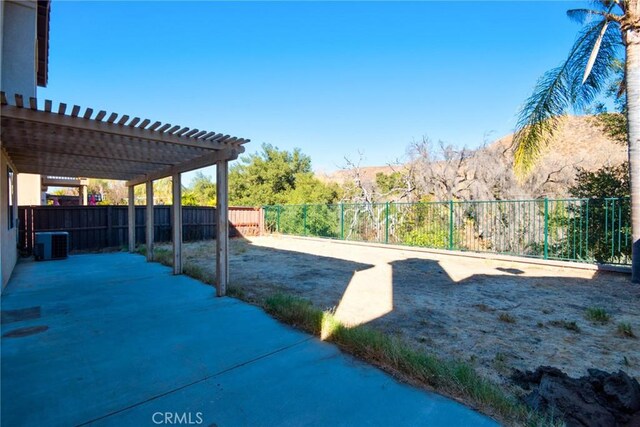 view of yard with a pergola, central air condition unit, and a patio