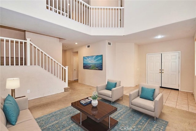 living room with a high ceiling and tile patterned floors