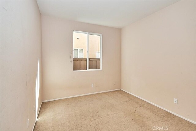 unfurnished room with light colored carpet