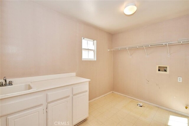 washroom with sink, cabinets, and washer hookup