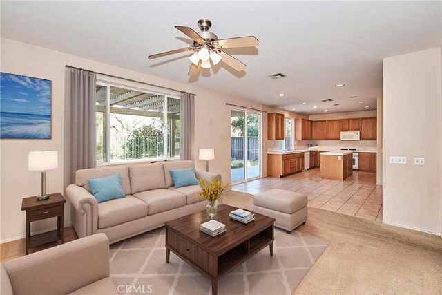 tiled living room featuring ceiling fan