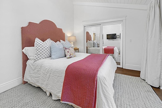 bedroom with vaulted ceiling with beams