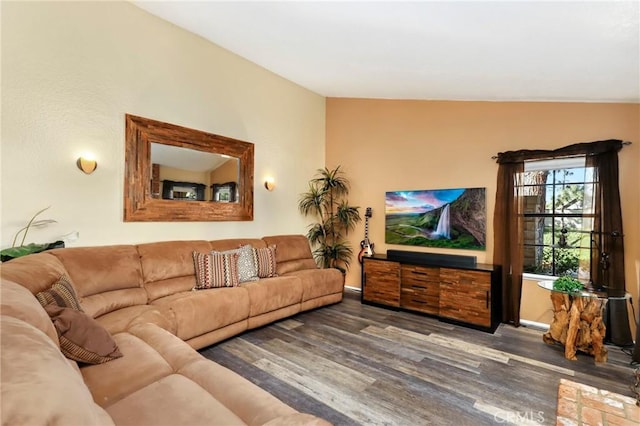 living room featuring dark wood-type flooring and vaulted ceiling