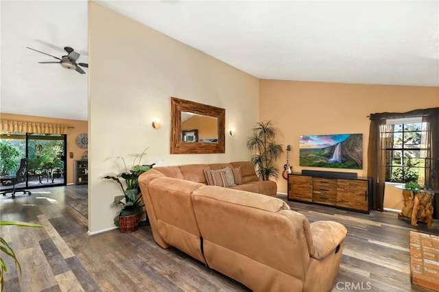 living room featuring dark hardwood / wood-style flooring, ceiling fan, and vaulted ceiling