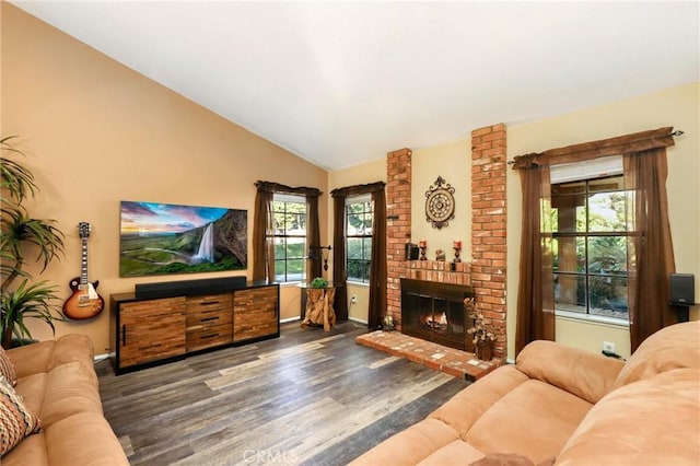 living room with lofted ceiling, dark hardwood / wood-style flooring, and a brick fireplace