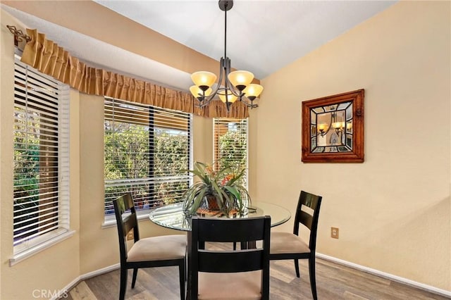 dining space featuring a chandelier and wood-type flooring