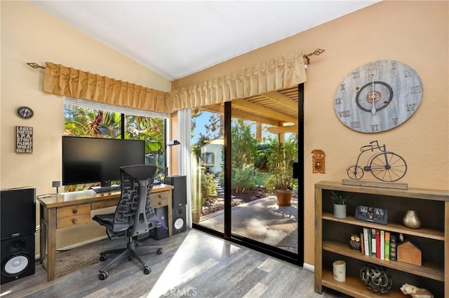 office space with light wood-type flooring and lofted ceiling