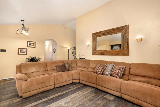 living room featuring lofted ceiling, a notable chandelier, and dark hardwood / wood-style flooring