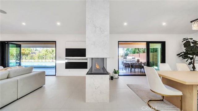 living room with a high end fireplace and a wealth of natural light