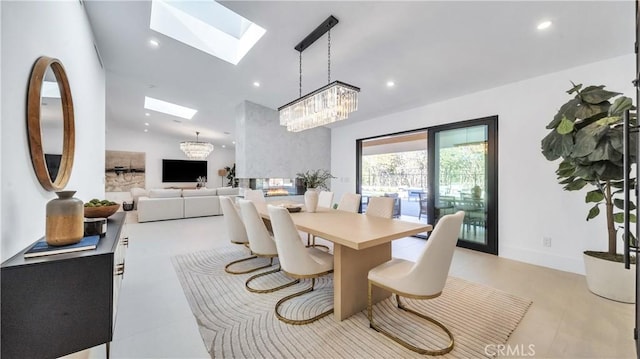 dining area featuring an inviting chandelier and lofted ceiling with skylight