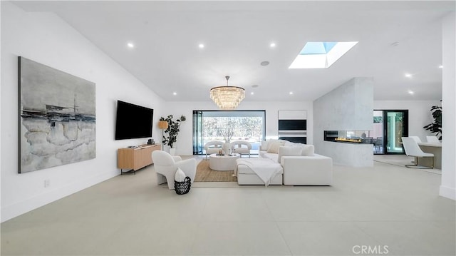 living room with an inviting chandelier, vaulted ceiling with skylight, and a multi sided fireplace