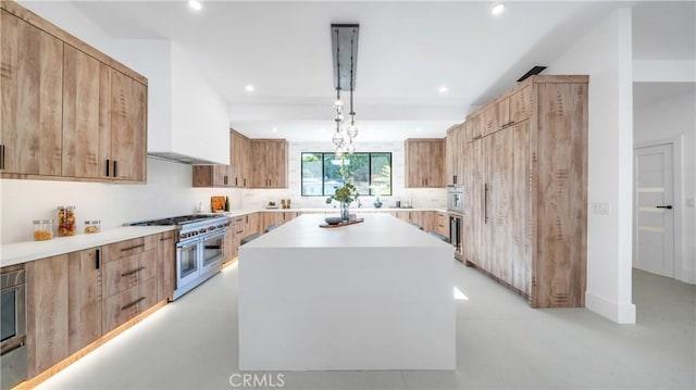 kitchen with hanging light fixtures, premium range hood, range with two ovens, and a center island