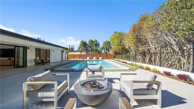 view of swimming pool with an outdoor fire pit and a patio