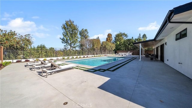 view of swimming pool with a patio