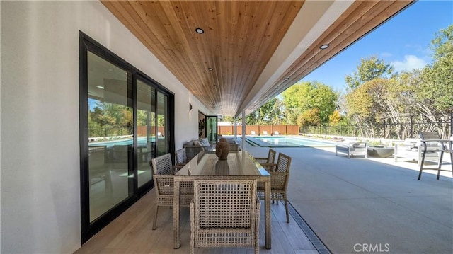 view of patio / terrace with a fenced in pool