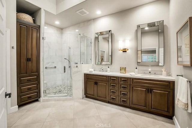 bathroom with walk in shower, tile patterned floors, and vanity