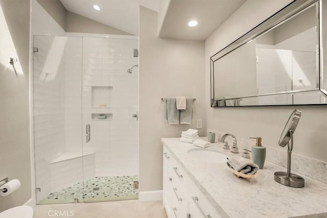 bathroom featuring a shower with door, tile patterned floors, and vanity